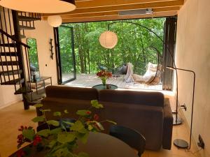a living room with a couch and a large window at Wyszumiane in Staniszów