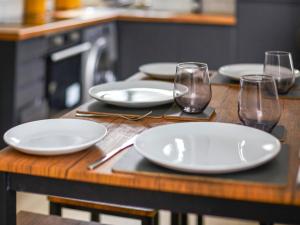 a wooden table with white plates and glasses on it at Green Mill 8 - Uk51369 in Holmfirth