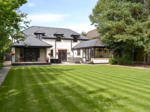 a house with a large lawn in front of it at Castlebar in Little Singleton