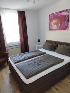 a bedroom with a large bed in a room at Pension Chapeau-Claque in Cochem