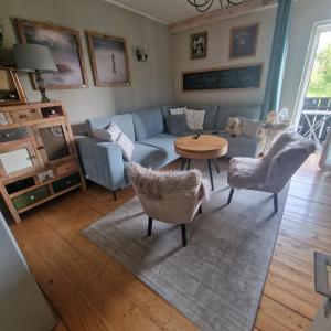 a living room with a couch and chairs and a table at Seelenversteck Oberaichwald in Latschach
