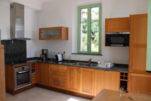 a kitchen with wooden cabinets and a sink at La bastide in Vallauris