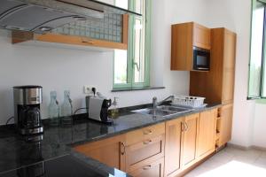 a kitchen with a sink and a microwave at La bastide in Vallauris +22 photos