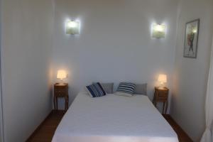 a bedroom with a bed with two lamps on it at La bastide in Vallauris