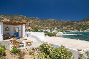 a house with a patio with a view of the water at Archipelago Sifnos - Seaside Accommodation in Vathi