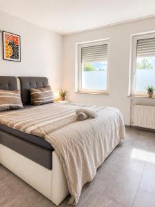 a bedroom with a large bed with a stuffed animal on it at Appartement in Mönchengladbach 2 Zimmer in Mönchengladbach