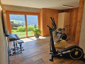 a room with a gym with exercise equipment and a window at Chesa Bunita Dus in Gaschurn