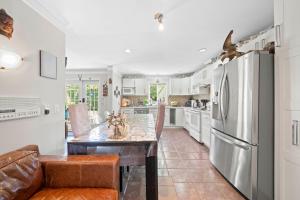 a kitchen with a table and a refrigerator at Royalty B&B in Richmond