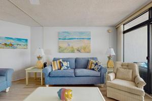 a living room with a blue couch and a chair at Pyramid 6K in Ocean City