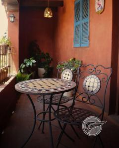 a table and two chairs on a porch with a table at Loft Michelle in Santeagueda