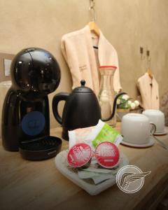 a table with affeepot and a coffee maker and a tea kettle at Loft Michelle in Santeagueda