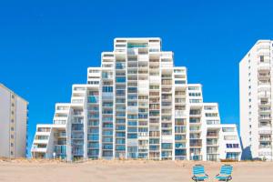 two chairs on the beach in front of a large building at Pyramid 10C in Ocean City