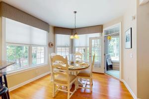 a dining room with a table and chairs at The Point 1437 in Ocean Pines
