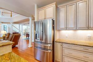 a kitchen with a stainless steel refrigerator in a room at The Point 1437 in Ocean Pines