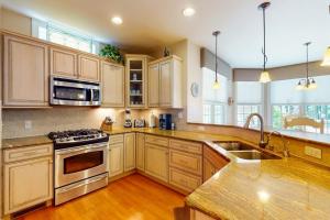 a kitchen with white cabinets and a stove top oven at The Point 1437 in Ocean Pines