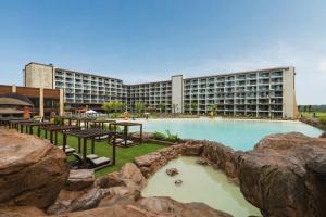 a hotel with a large pool in front of a building at Tauá Hotel e Convention João pessoa in João Pessoa