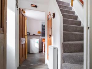 a hallway with stairs in a house at Needle Cottage in Cullen