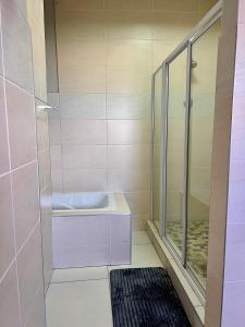 a bathroom with a sink and a shower at Kairos Guest House in Maseru