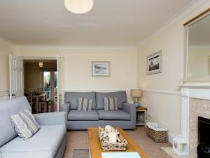 a living room with a couch and a fireplace at Peacehaven in Shalfleet