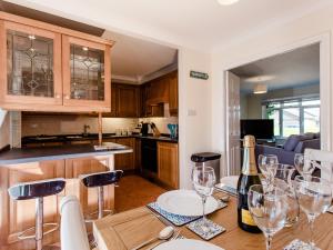 a kitchen with a table with wine glasses on it at Peacehaven in Shalfleet +15 photos