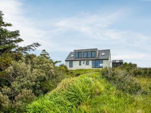 a house on top of a hill with grass at Grianan in Eriskay