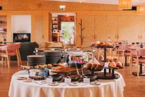 a table with various pastries and other food on it at Estrela Serenity - Mountain Resort in Folgosinho