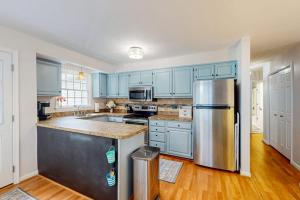 a kitchen with blue cabinets and a stainless steel refrigerator at 838 Ocean Parkway in Ocean Pines