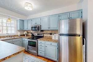 a kitchen with blue cabinets and a stainless steel refrigerator at 838 Ocean Parkway in Ocean Pines