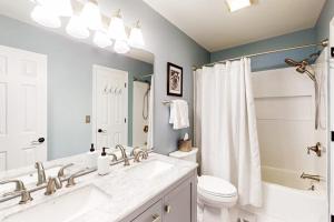 a white bathroom with a sink and a toilet at 838 Ocean Parkway in Ocean Pines +8 photos