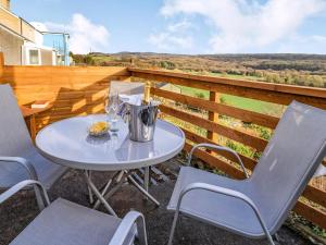 a table and chairs on the balcony of a house at Number 4 in Llandeilo