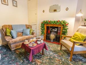 a living room with a couch and a fireplace at Number 4 in Llandeilo +24 photos