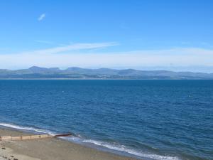 a view of the ocean from the beach at Glan Y Mor - Uk52092 in Criccieth