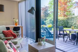 a living room with a view of a patio at ParelDuyn in Oostkapelle