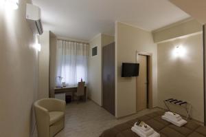 a hotel room with a bed and a chair and a desk at B&B Del Corso in San Cataldo
