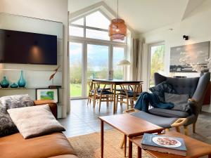 a living room with a couch and a table at Fliederuferhaus in Kosel