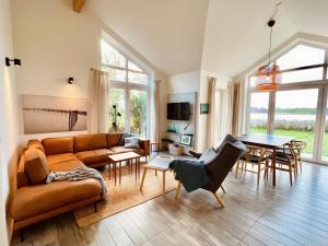 a living room with a couch and a table at Fliederuferhaus in Kosel