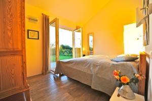 a bedroom with a bed and a cross on a table at Fliederuferhaus in Kosel