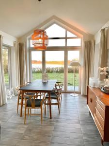a dining room with a table and chairs at Fliederuferhaus in Kosel +15 photos