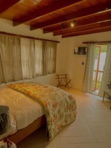 a bedroom with a bed in a room with windows at Casa Úrsula in Panama City
