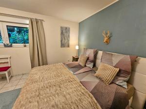 a bedroom with a bed and a couch at Eifelglück in Heimbach