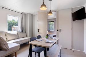a living room with a table and a couch at Mobilehome Vallon 49 in Saint-Gervais