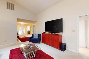 a living room with a flat screen tv on a red cabinet at 22 Harpoon rd in Ocean Pines