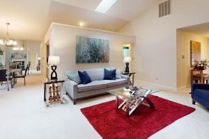 a living room with a couch and a red rug at 22 Harpoon rd in Ocean Pines