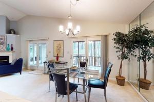 a living room with a dining room table and chairs at 22 Harpoon rd in Ocean Pines
