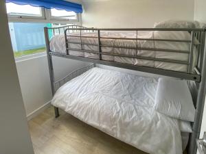 a couple of bunk beds in a room at Sea Pearl in Kessingland