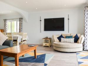 a living room with a couch and a table at The Dawn in Looe