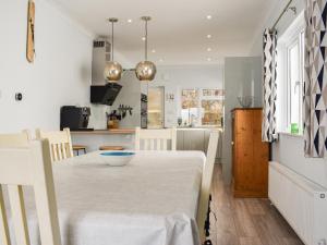 a kitchen and dining room with a table and chairs at The Dawn in Looe +17 photos