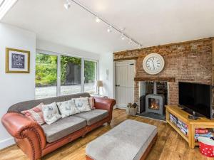 a living room with a couch and a fireplace at Heath Hills in Okehampton