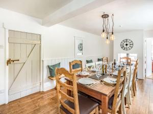 a dining room with a wooden table and chairs at Heath Hills in Okehampton +33 photos