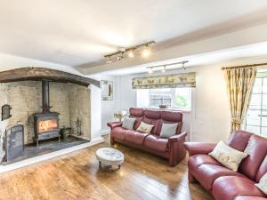 a living room with a couch and a fireplace at Heath Hills in Okehampton